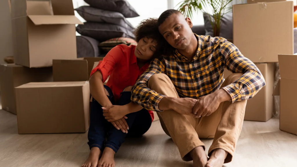 Unhappy couple in home with moving boxes - breach of separation agreement