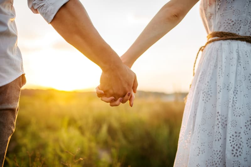 Couple holding hands after signing a prenuptial agreement
