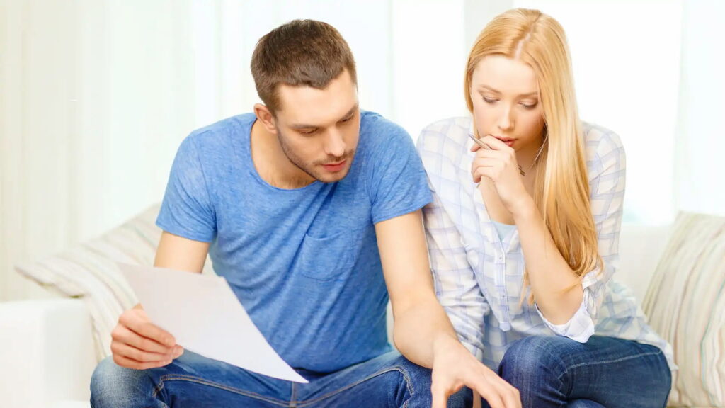 What does contracting out mean in law? Family couple looking at the papers.
