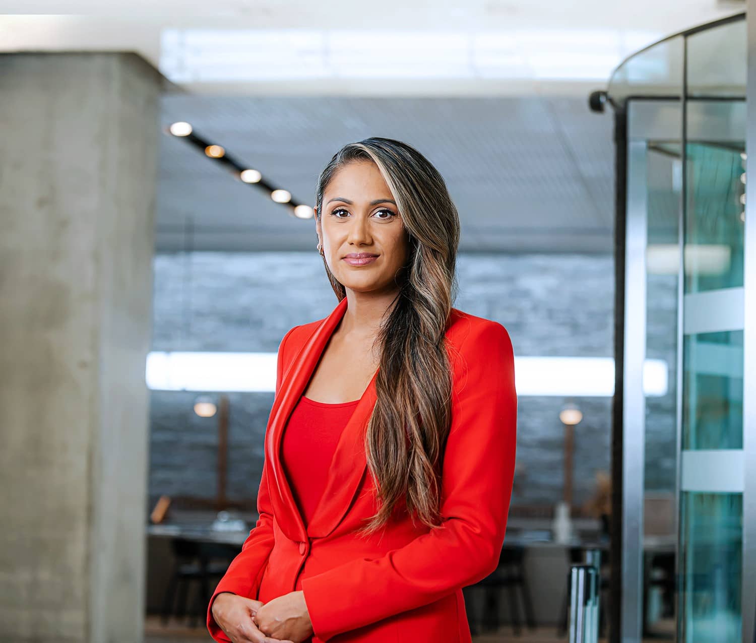 Photo of Sharon Chandra wearing red business suit