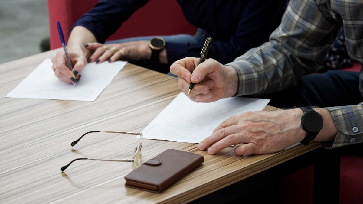 Couple signing spousal maintenance forms in New Zealand